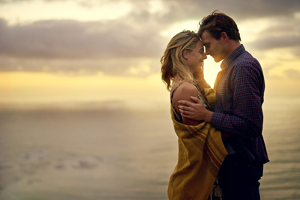 Shot of an affectionate young couple sharing a tender moment at sunset